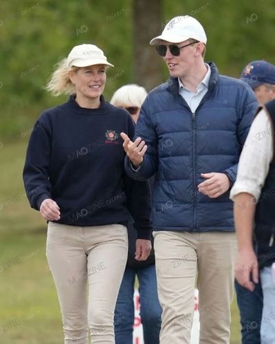 Lady Louise Windsor laughing and walking with rumored boyfriend Felix da Silva-Clamp in casual attire.