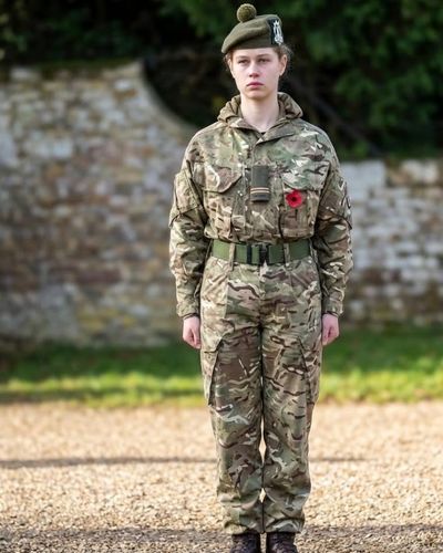 Lady Louise Windsor standing at attention in full camouflage military uniform during UOTC training.