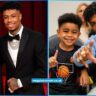 Blueface and his son Javaughn J. Porter pose together on the red carpet in formal suits at a 2025 event