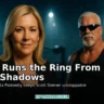 Christa Podsedly in sharp focus with Scott Steiner behind her by the wrestling ring under dramatic spotlights