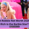 Margot Robbie in 2025 smiling at a red carpet event, highlighting her net worth and Hollywood success