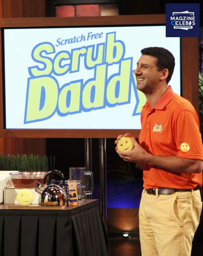 Aaron Krause presenting Scrub Daddy sponge on Shark Tank with the brand logo displayed in the background, 2025
