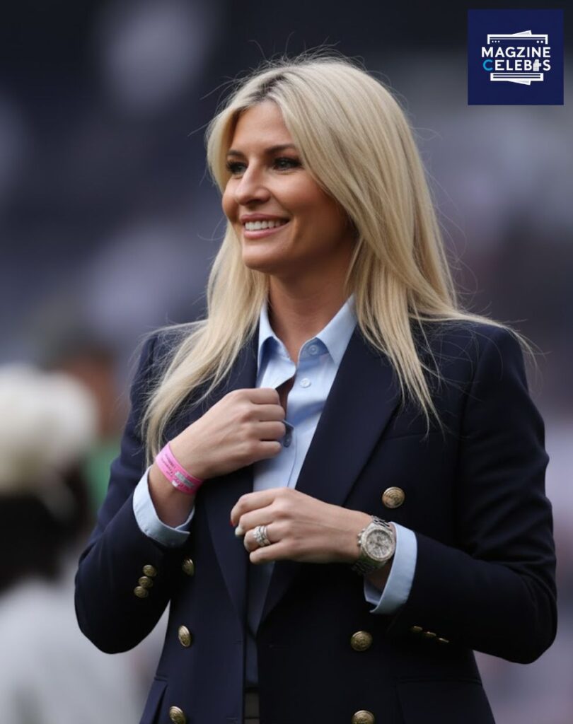 Georgia Postecoglou smiling in a navy blazer and blue shirt during a football event – confident and elegant portrait 2025