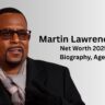 Martin Lawrence smiling in black suit and scarf - Net Worth 2025, Biography, Age | Magzine Celebs