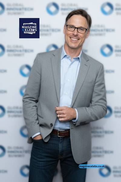 Nicholas Taylor Begley portrait in grey blazer at Global Innovation Tech Summit — professional photo used for biography on MagzineCelebs.