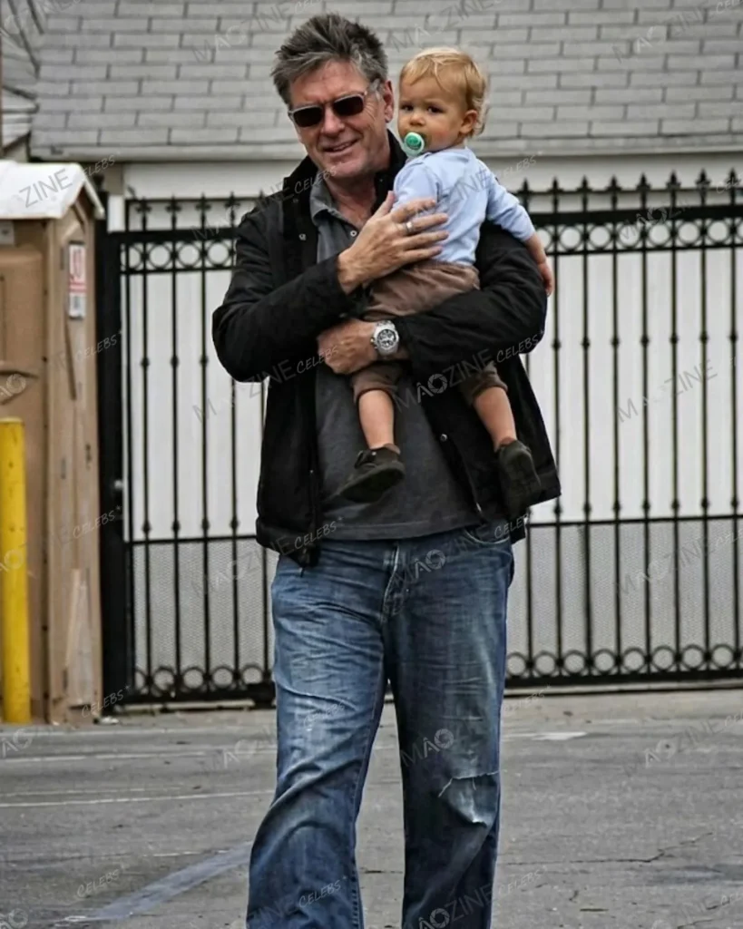 Comedian Craig Ferguson wearing sunglasses and holding his youngest son, Liam James Ferguson, as a toddler.