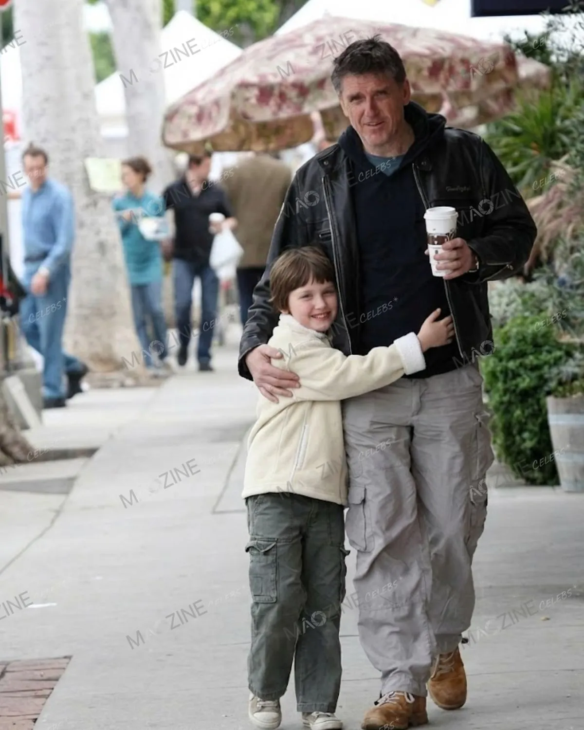 Craig Ferguson walking casually on the street with his arm around his young son Milo Hamish Ferguson.