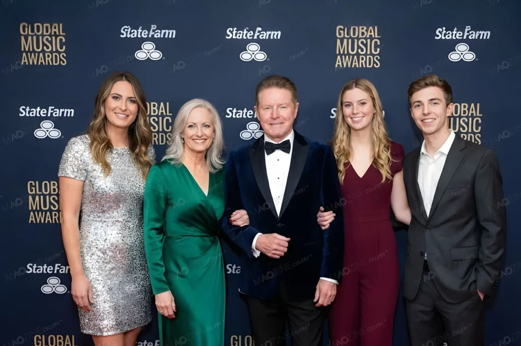 Don Henley and his wife Sharon Summerall pose on the red carpet of the Global Music Awards with their three adult children: daughters Annabel and Julia, and son Will. Sharon is wearing an emerald green dress, and the family is smiling at the camera.