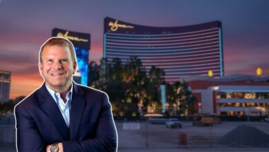 Tilman Fertitta in front of Wynn Resorts Las Vegas and his halted hotel project site, illustrating the conflict of interest.