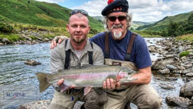 Sir Billy Connolly and his eldest son Jamie Connolly holding a large rainbow trout while fishing in a river in New Zealand.