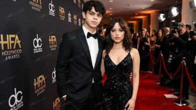 Isaac Ortega standing next to his sister Jenna Ortega at a formal red carpet event.
