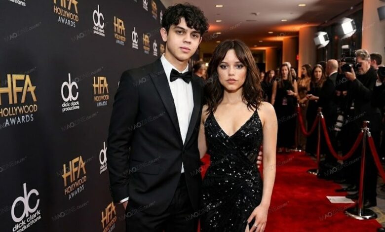 Isaac Ortega standing next to his sister Jenna Ortega at a formal red carpet event.