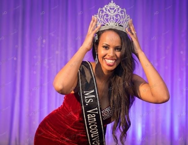 Young Sabrina Dhowre being crowned Ms. Vancouver 2014 wearing a red velvet pageant dress.
