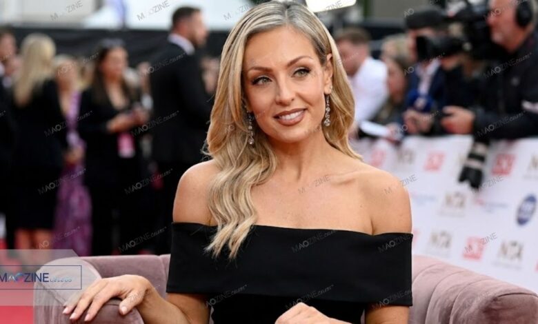 Amy Dowden smiling in a black off-shoulder dress at the National Television Awards (NTA) red carpet.