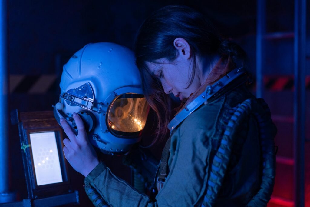 Woman holding astronaut helmet thoughtfully.